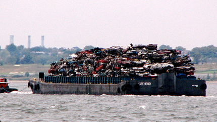 garbage barge sailing past the Statue of Liberty