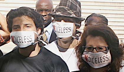 Photo of protesters wearing 'Voiceless' masks.