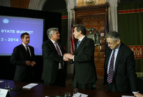 Four men working out a state budget