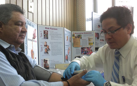 Marcelo Villagran administers a glucose test to driver Rafael Fernandez, age 62.