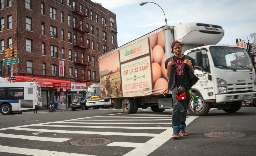 young man crossing street