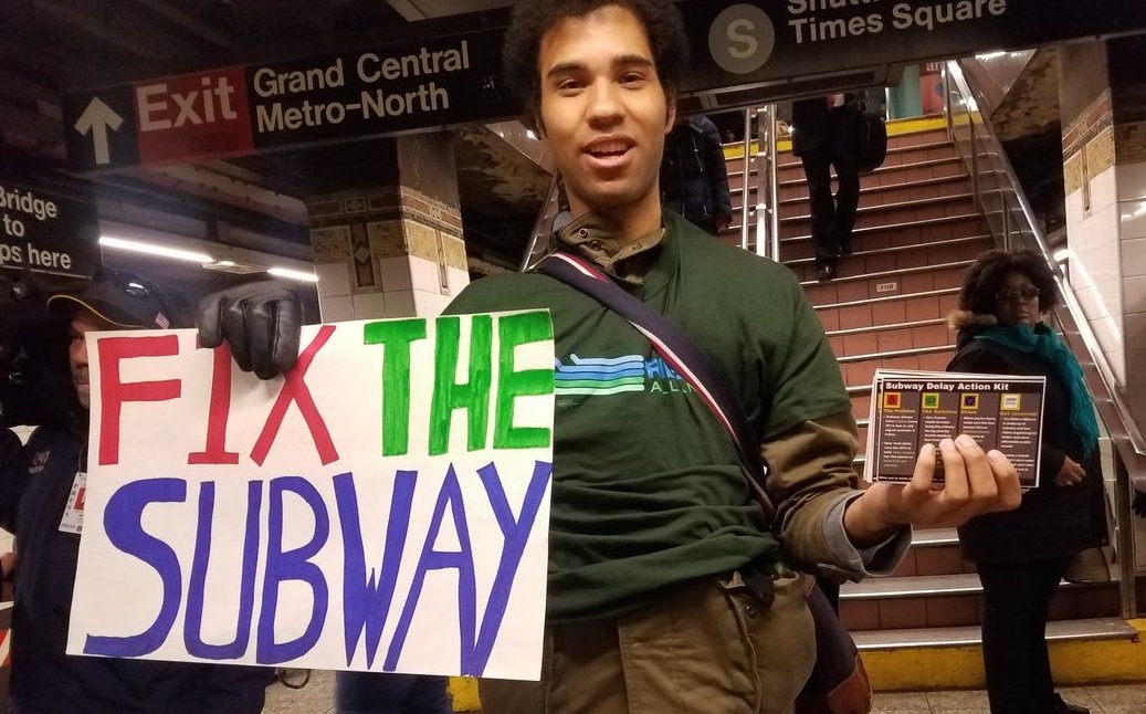 riders fix the subway sign